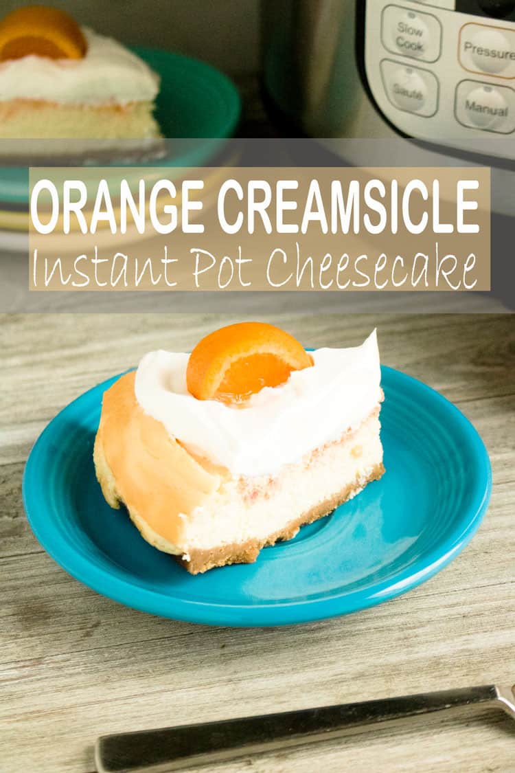 orange creamsicle cheesecake with an orange slice on top of it on a blue plate