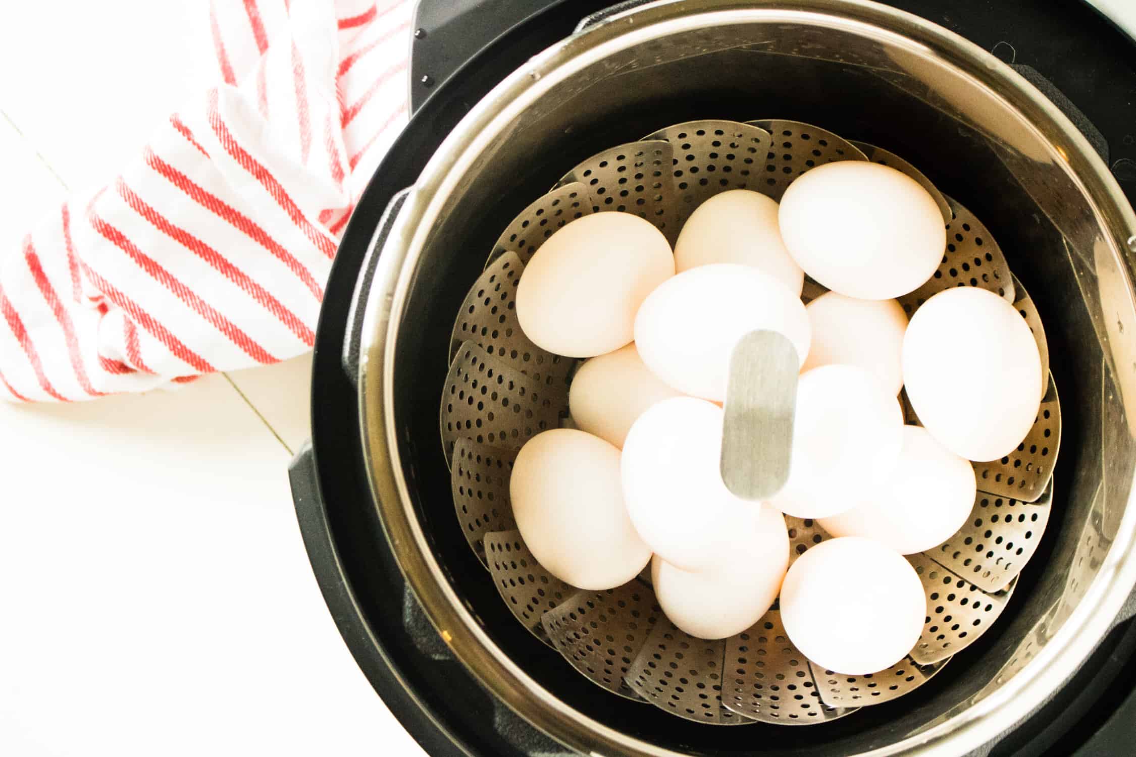 view looking down into instant pot at eggs for Instant Pot Hard Boiled Eggs sitting in steaming basket inside the Instant Pot