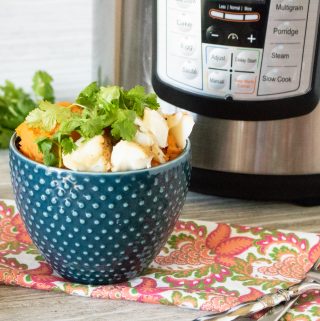 Instant Pot Cod fillets served in a blue polka dot bowl and garnished with parsley