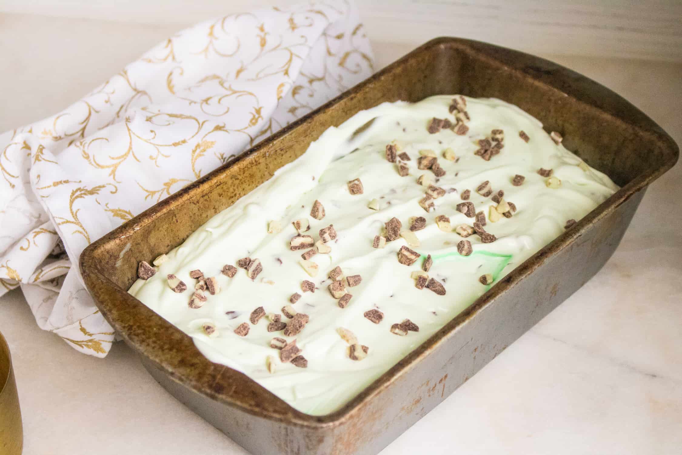 a rectangular freezer dish filled with mint chip no churn easy homemade ice cream