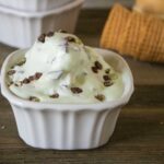 one scoop of mint chip no-churn ice cream served in a white square dessert dish