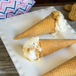 Nutter Butter No-Churn Ice Cream scooped into sugar cones and served on a white platter