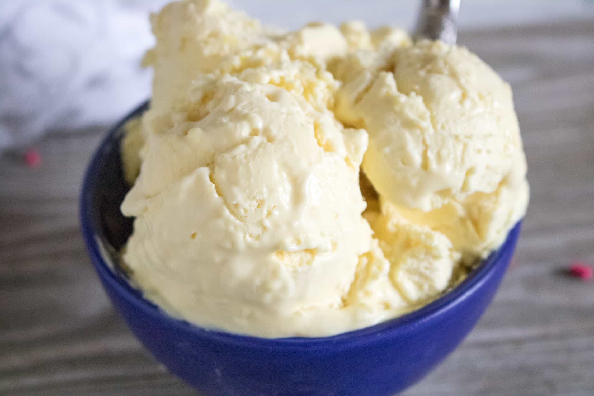 close-up view of a scoop of Lemonade No-Churn Ice Cream served in a blue dessert bowl