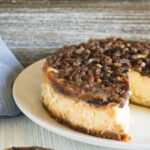 Finished Instant Pot Chocolate Pecan Cheesecake with one slice removed