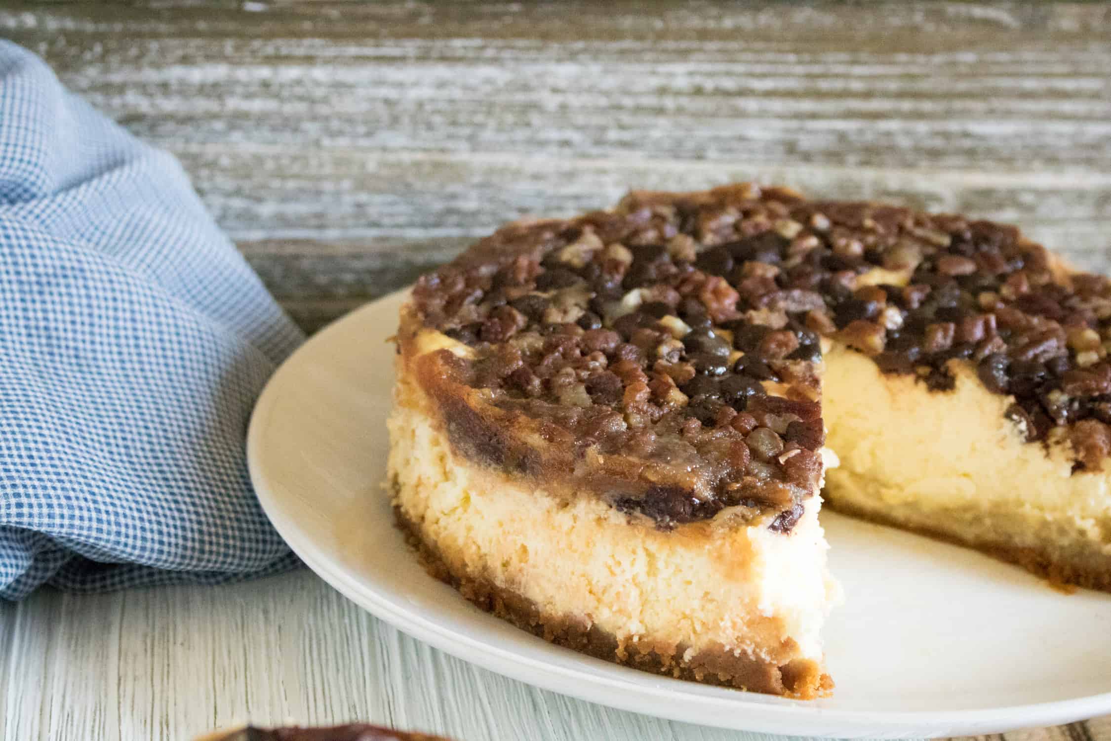 Finished Instant Pot Pecan Cheesecake with Chocolate Chips with one slice removed