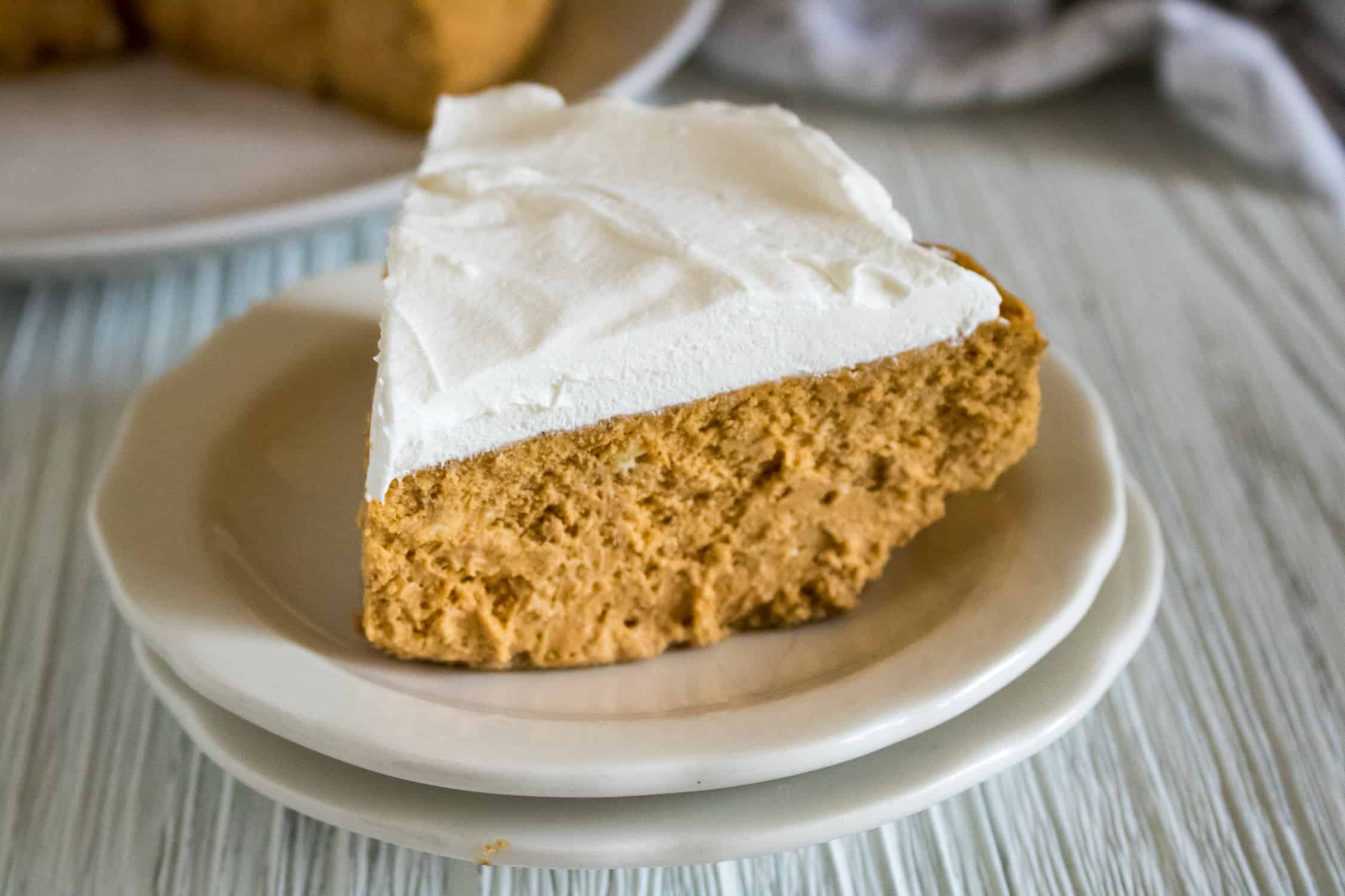 upclose picture of Instant Pot Pumpkin Cheesecake sitting on two white plates