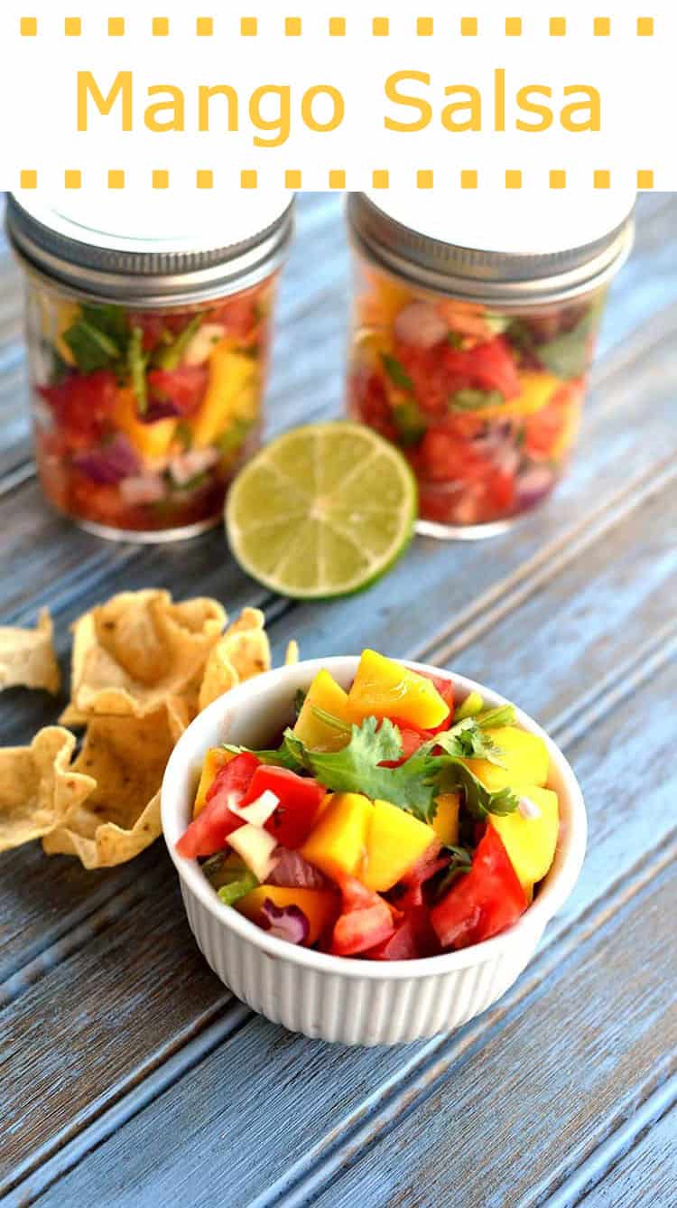 mango salsa in a white bowl with chips by it