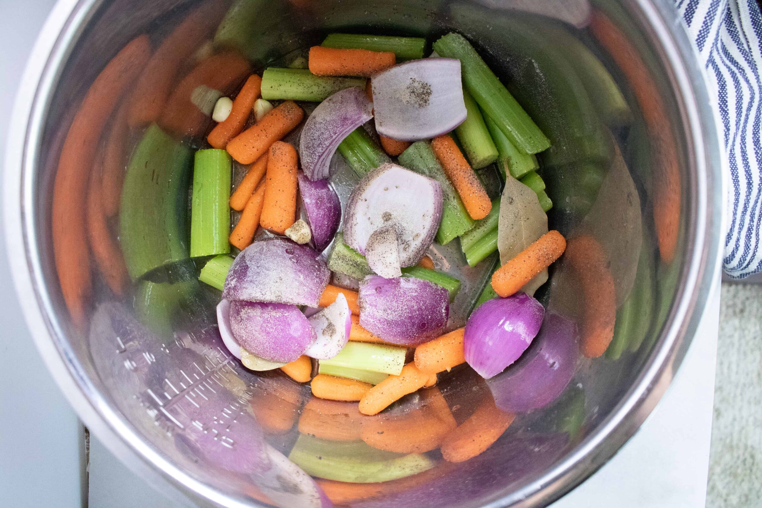 chopped vegetables placed at the bottom of the Instant Pot insert