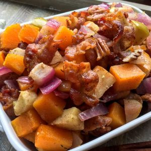 Apple Butternut Squash Casserole with Bacon Pecan Topping ready to serve in a white dish