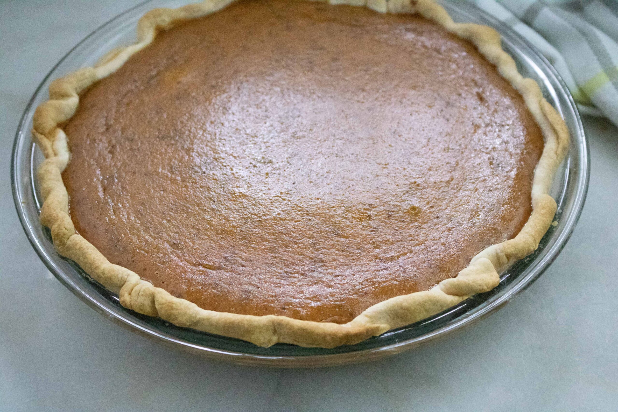 Completed Pumpkin Meringue Pie minus meringue in glass pie pan