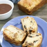 Permalink to: Apple Butter Coffee Cake 3 slices of Apple Butter Coffee Cake on a blue plate in front of a full loaf and small white bowl of apply butter