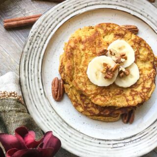 Paleo Pumpkin Spice Pancakes Topped with Sliced Bananas and Pecans