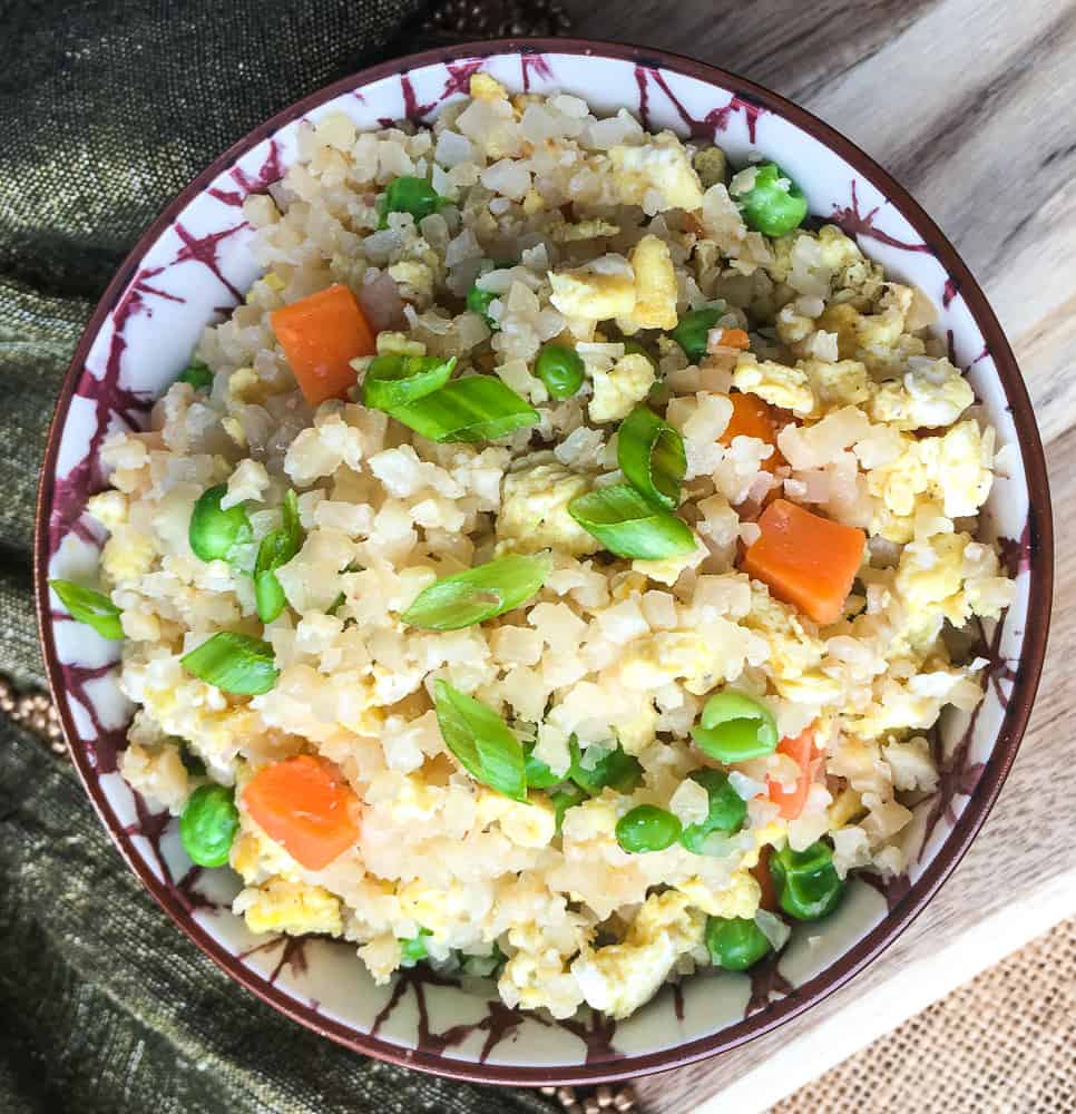 Low Carb Cauliflower Fried Rice in brown and white ceramic bowl
