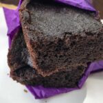 Permalink to: Low Carb Gluten Free Chocolate Cherry Brownies Recipe close up view of two Chocolate Cherry Brownies wrapped in a purple napkin