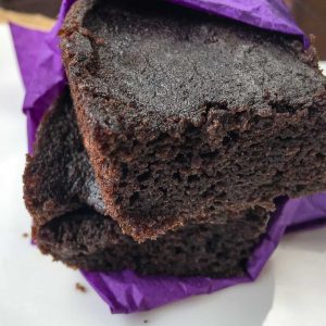 close up view of two Chocolate Cherry Brownies wrapped in a purple napkin