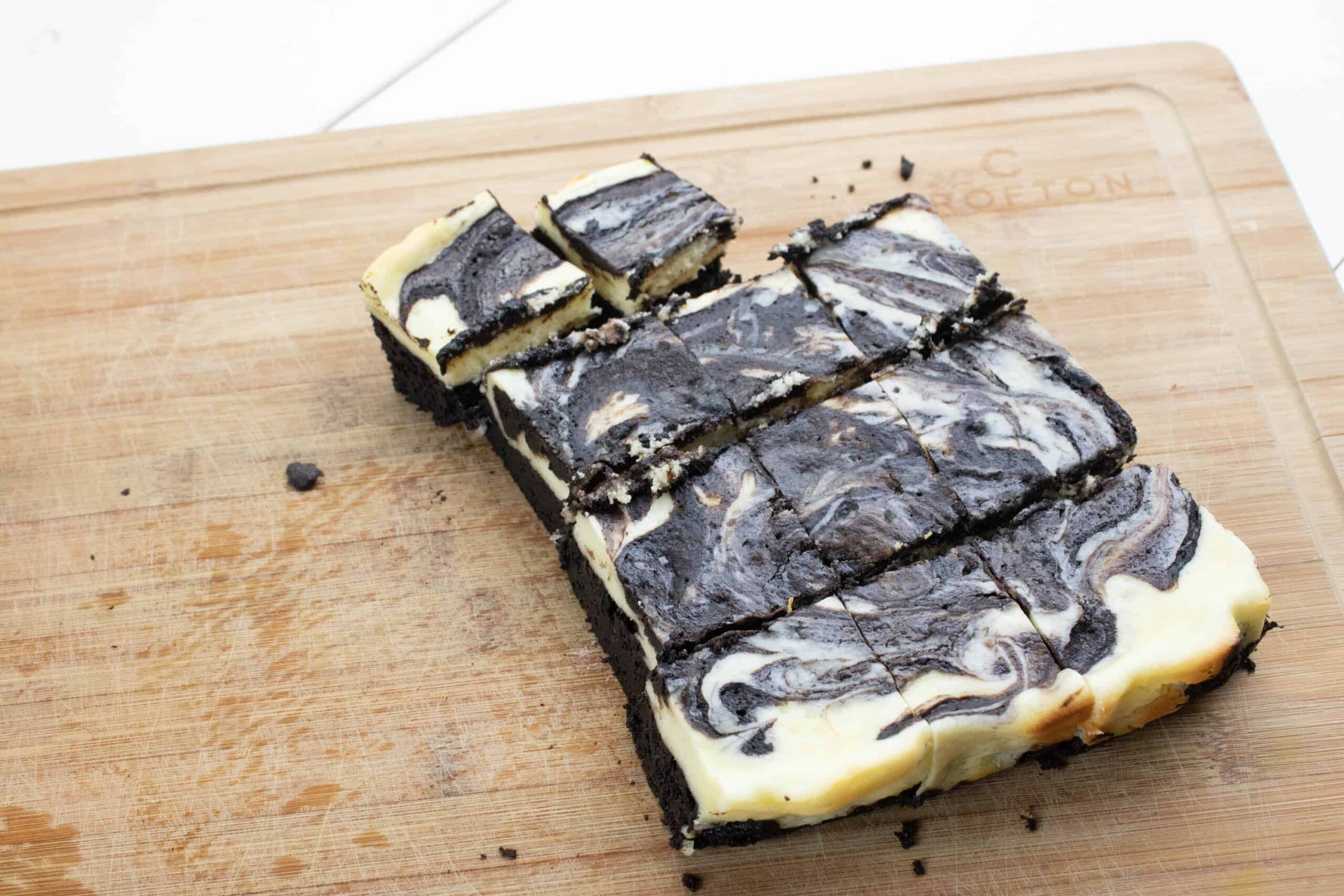 cooked cheesecake brownies cut into squares and ready to serve