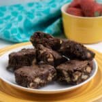 Permalink to: Chunky Brownies – The Ultimate Brownies Recipe A plate of ultimate chunky brownies served with a small bowl of strawberries