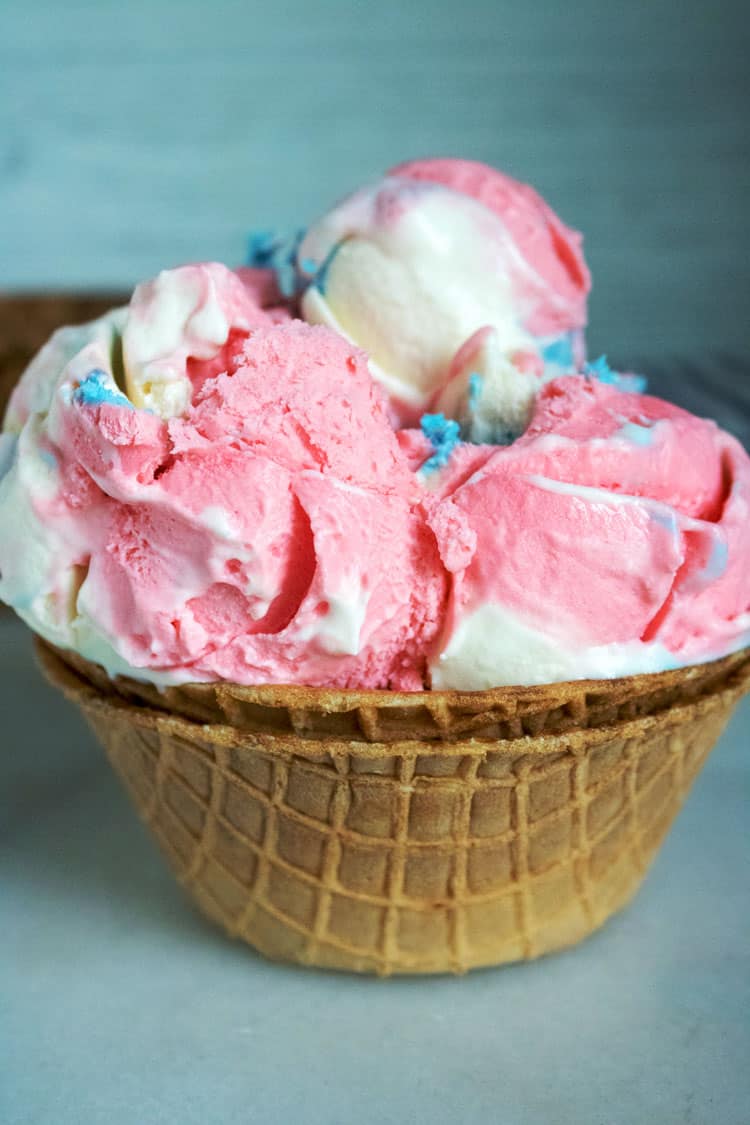 ice cream cone bowl stacked with 3 scoops of red, white and blue no-churn ice cream 4th of July Desserts