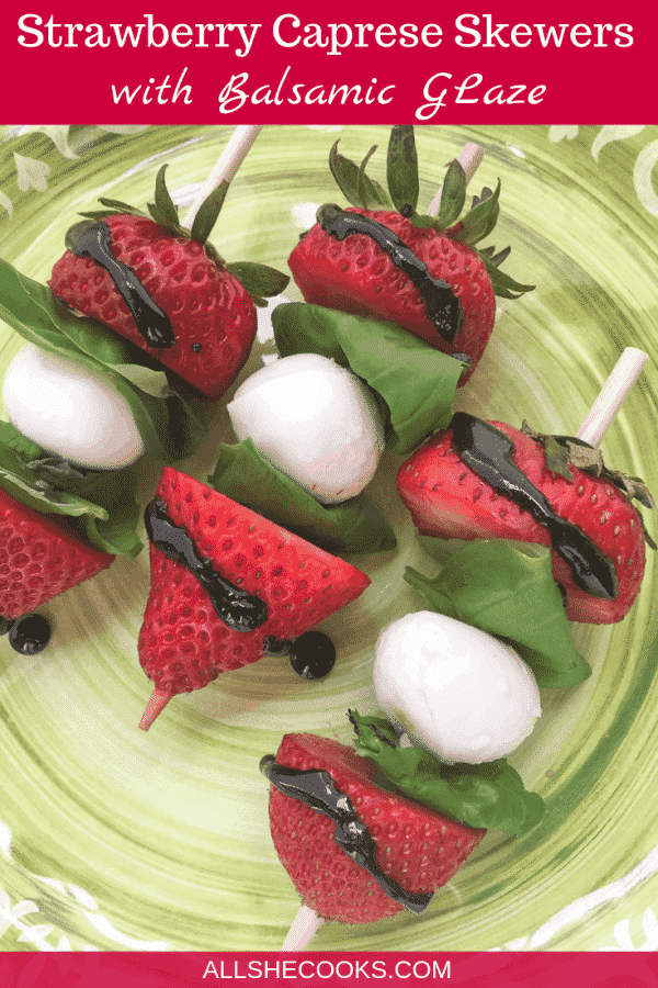 strawberry caprese skewers served on a green plate
