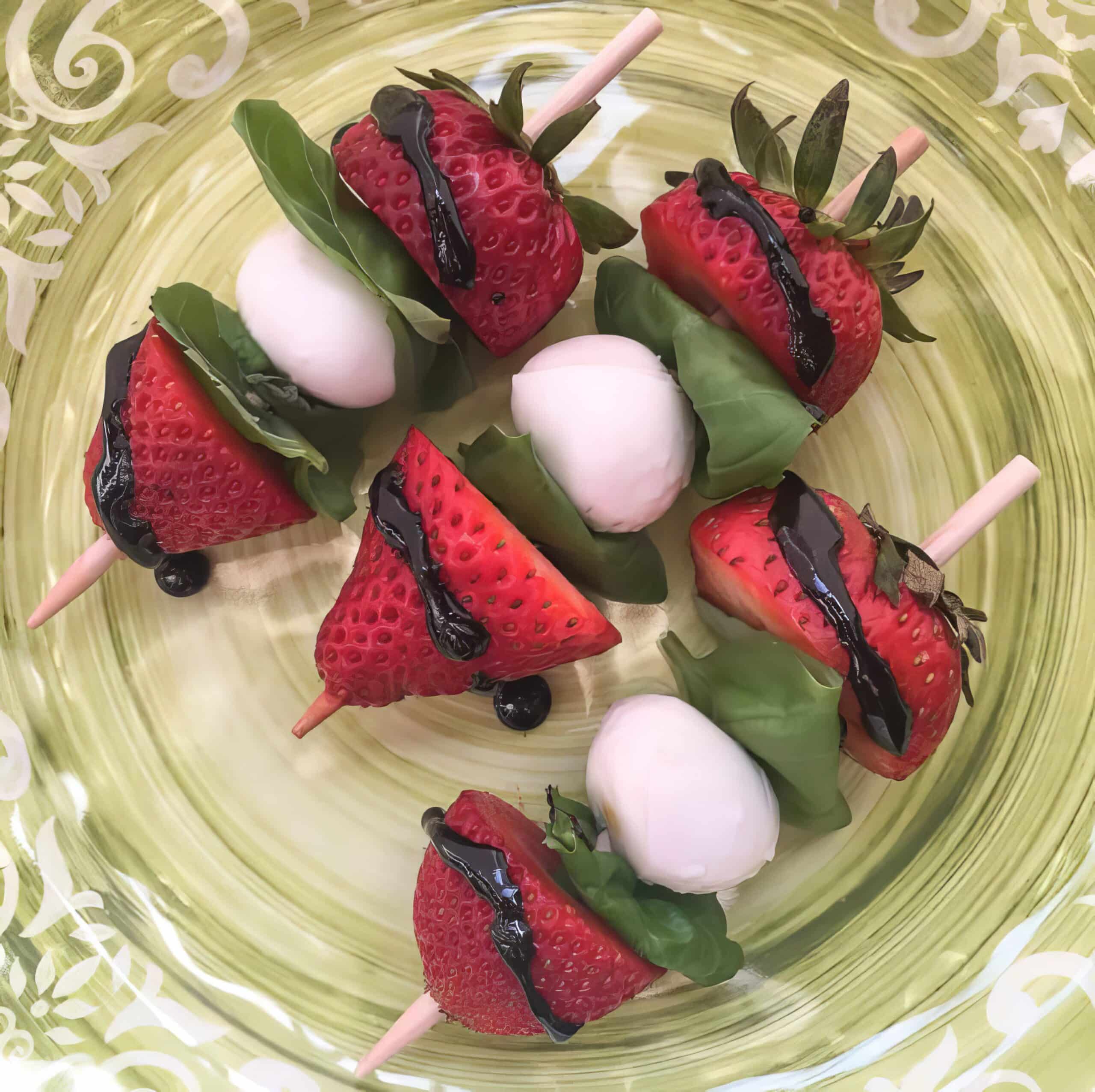 strawberry caprese skewers on a plate with balsamic glaze