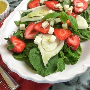 strawberry fennel salad served o a white platter