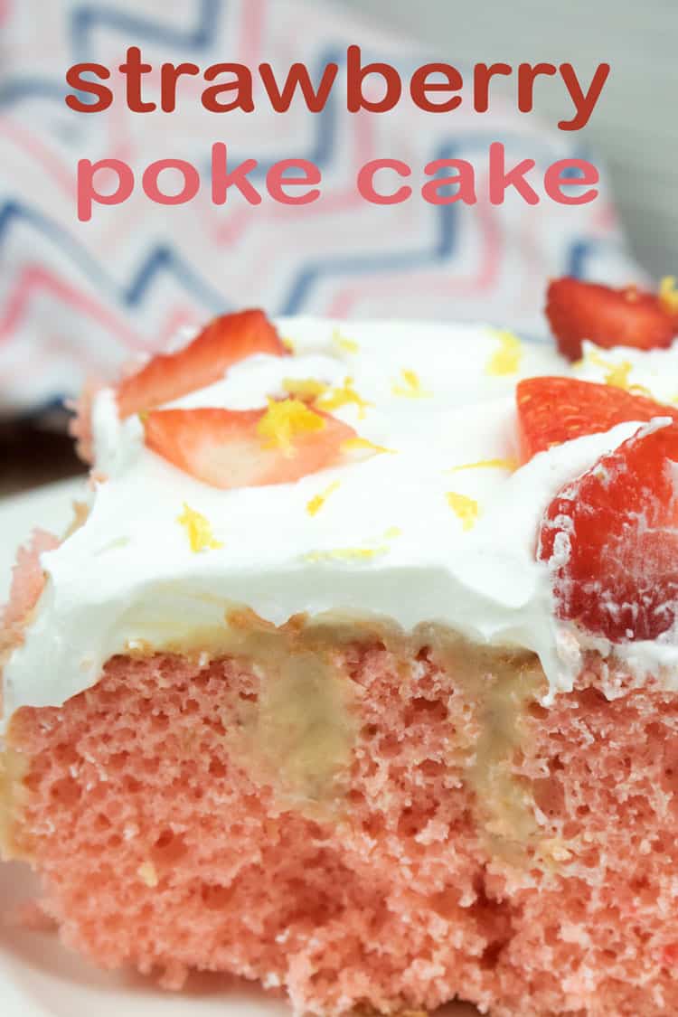 strawberry poke cake with whipped topping and sliced strawberries on top