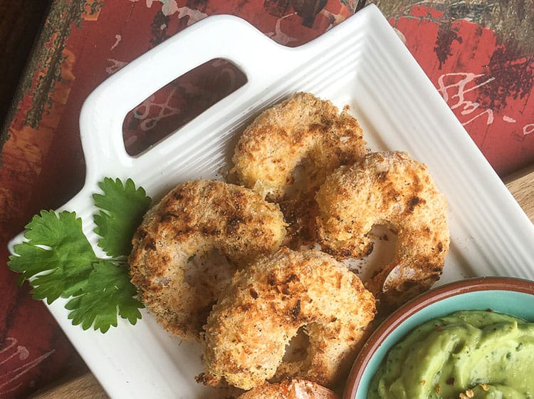 baked coconut shrimp on platter with avocado dipping sauce 