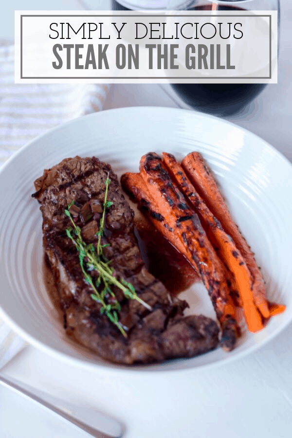 steak and glazed carrots on white plate and white background