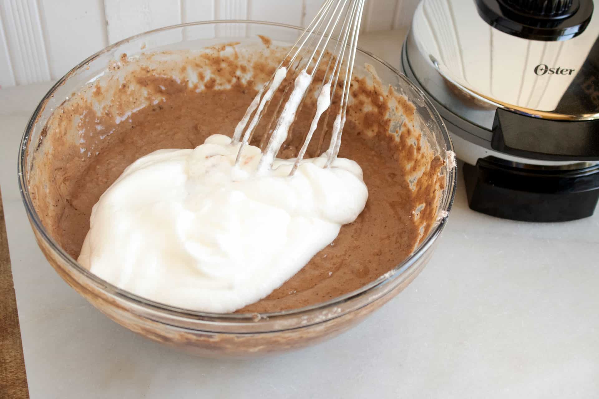 folding whipped egg whites into chocolate waffle batter