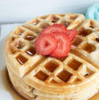 belgian waffles with strawberries on white plate