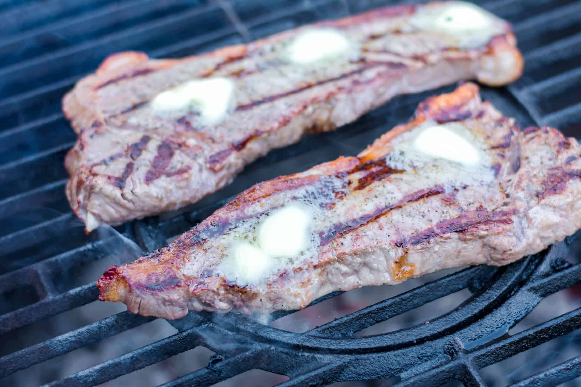 butter on top of grilled steaks