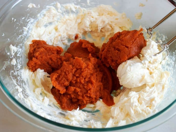 pumpkin puree and ingredients for a cream cheese pumpkin frosting in bowl