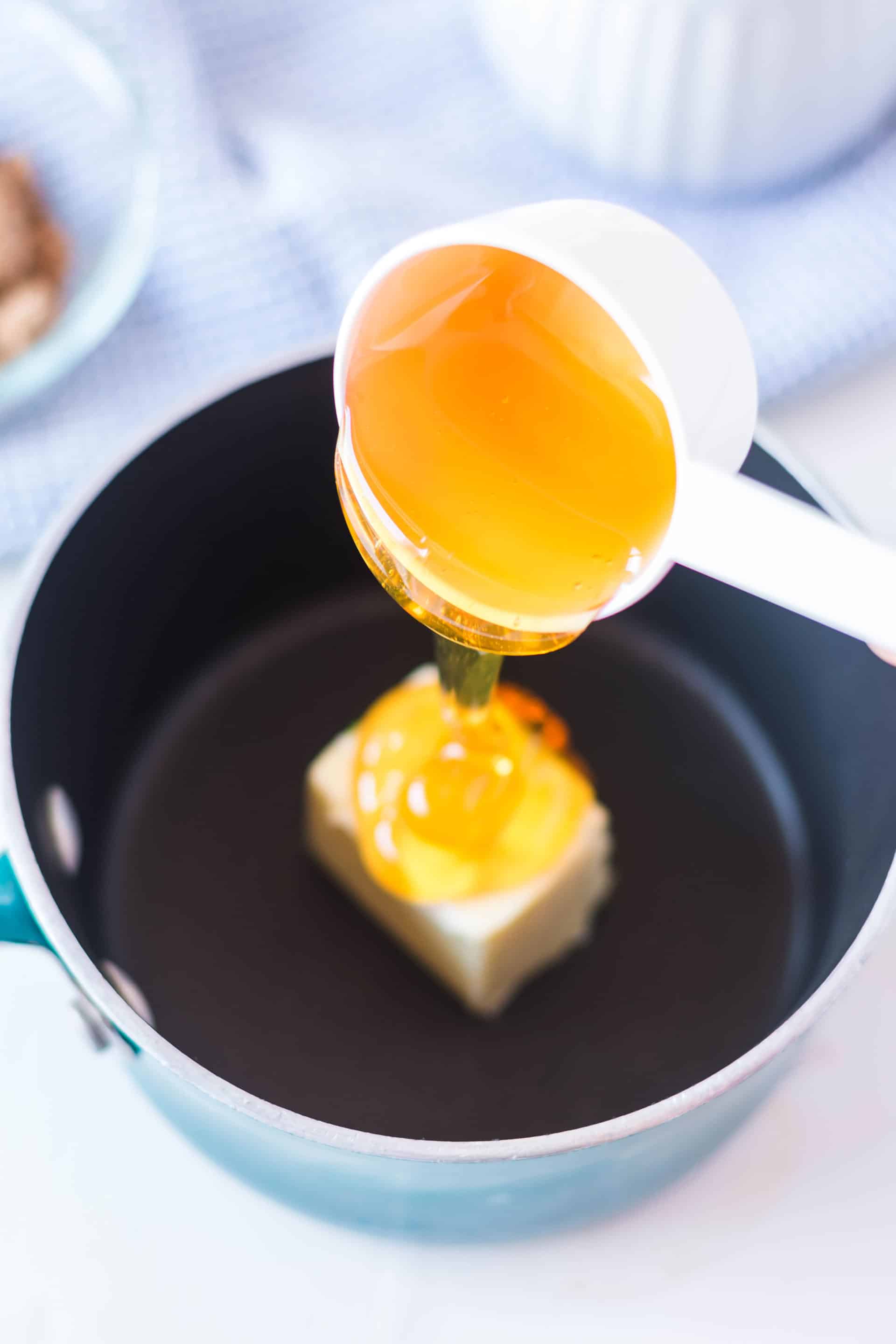 honey being poured into a pan
