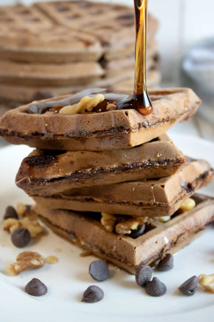 chocolate Belgian Waffles with syrup being poured on them