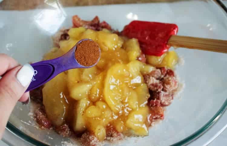 adding spices to pie filling in glass bowl