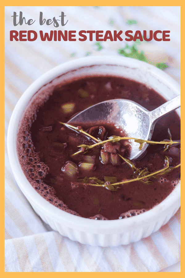 white ramekin with red wine steak sauce and a spoon resting in the bowl