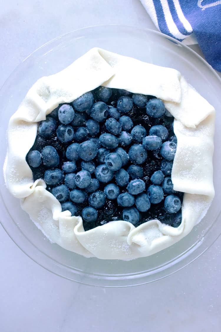 blueberry pie ready to bake. Pie crust filled with fresh blueberries.