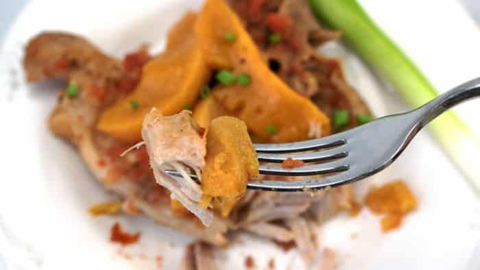 fork full of pork chops with peaches