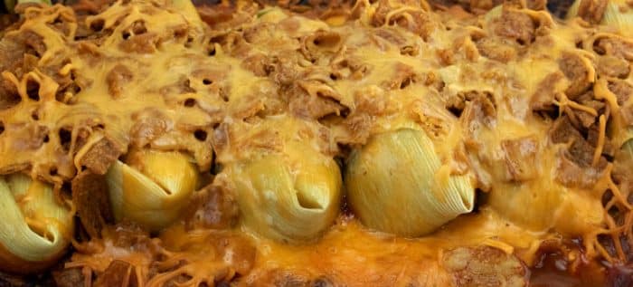tamales covered with melted cheese