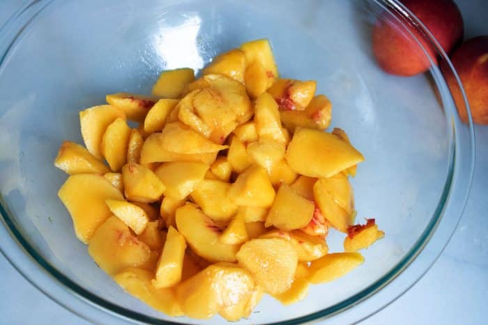 slices of peaches in mixing bowl