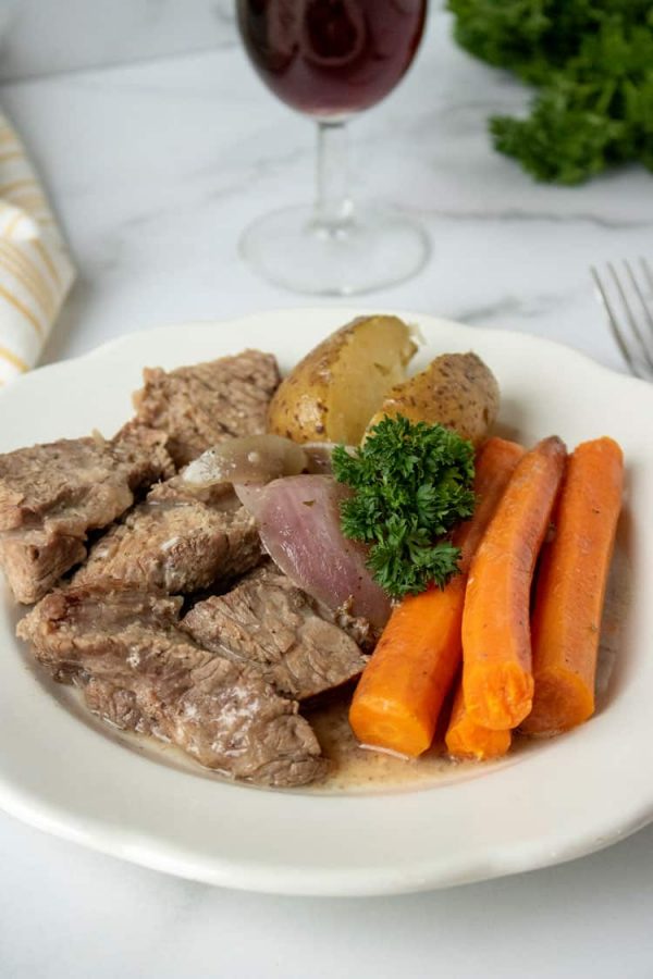 slow cooker pot roast on white plate with carrots