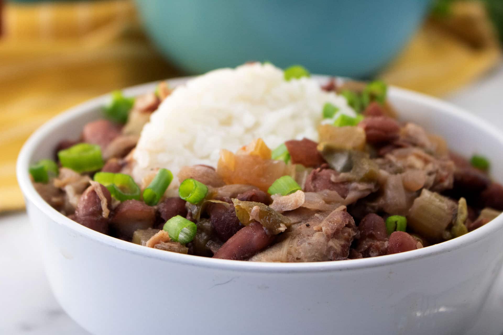 Close-up of slow cooker red beans and rice with ham and scallions