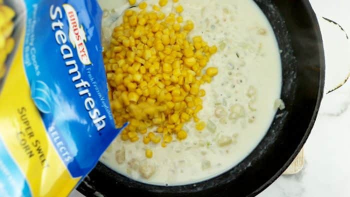 adding the corn kernels to the pan