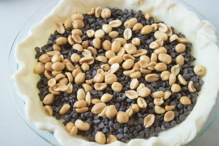 Sprinkle chocolate chips and peanuts over the pie crust