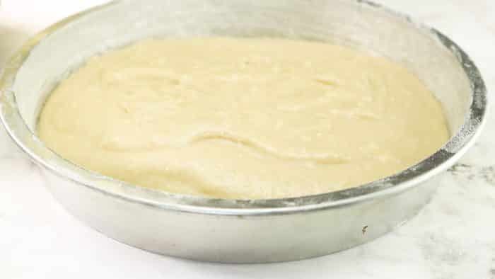 smoothing out the cake batter on the bottom of the pan
