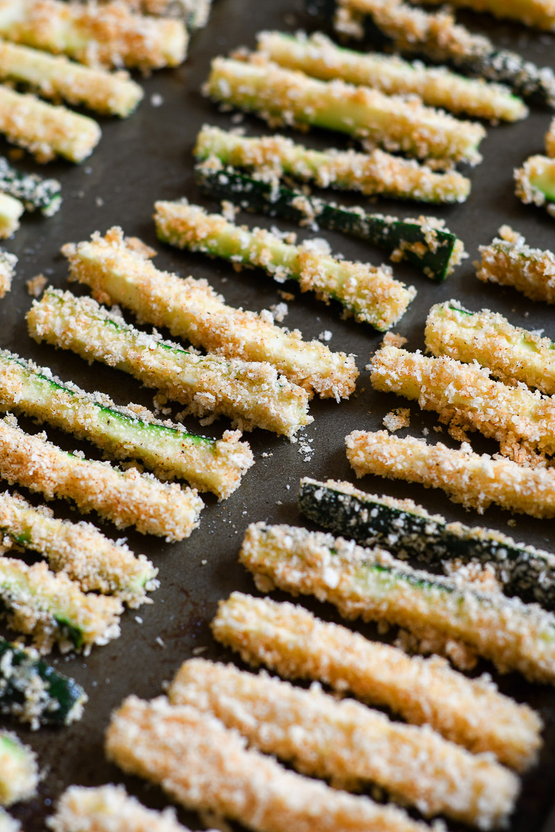 zucchini fries on a baking sheet