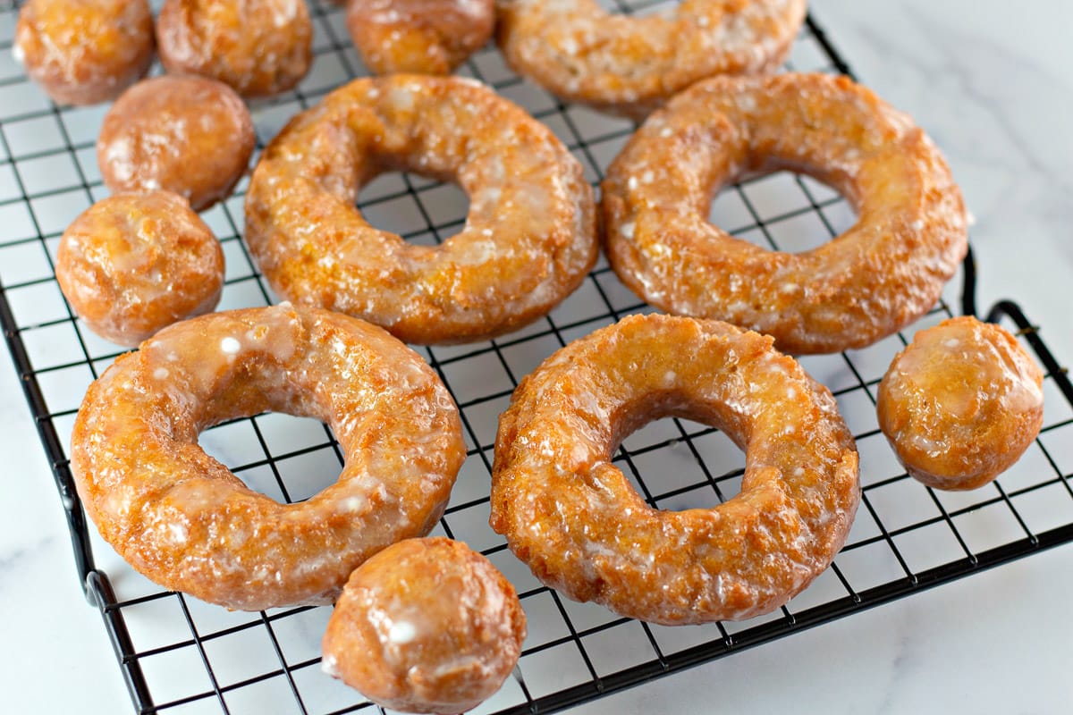 pumpkin donuts and donut holes on a cooling rack