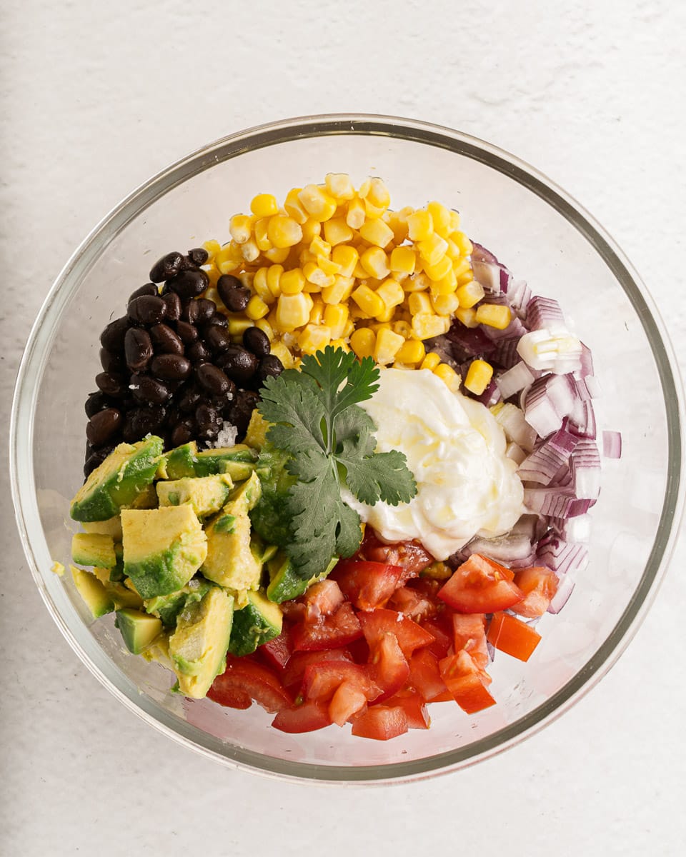 bowl of ingredients for black bean corn avocado salad