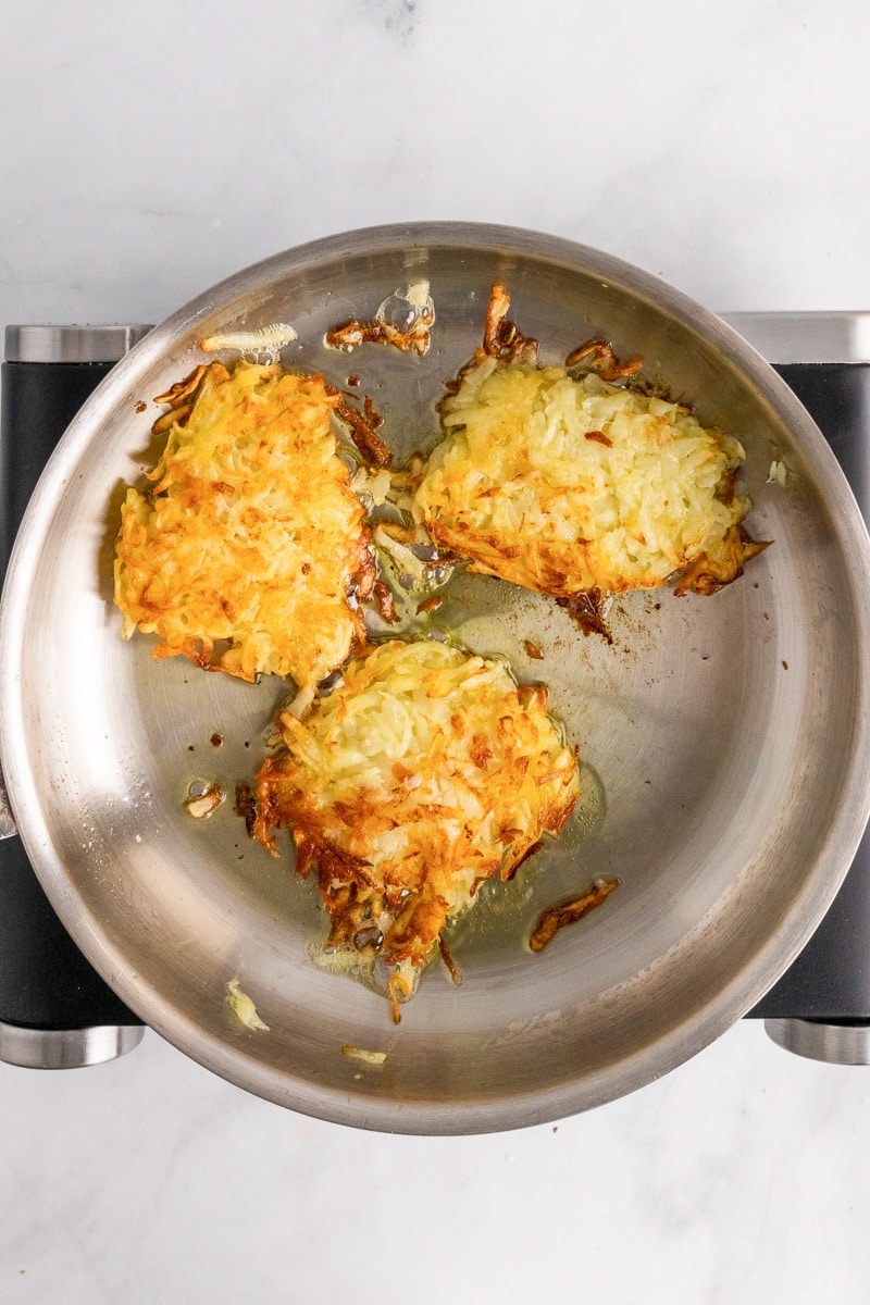 german potato pancakes frying in a pan