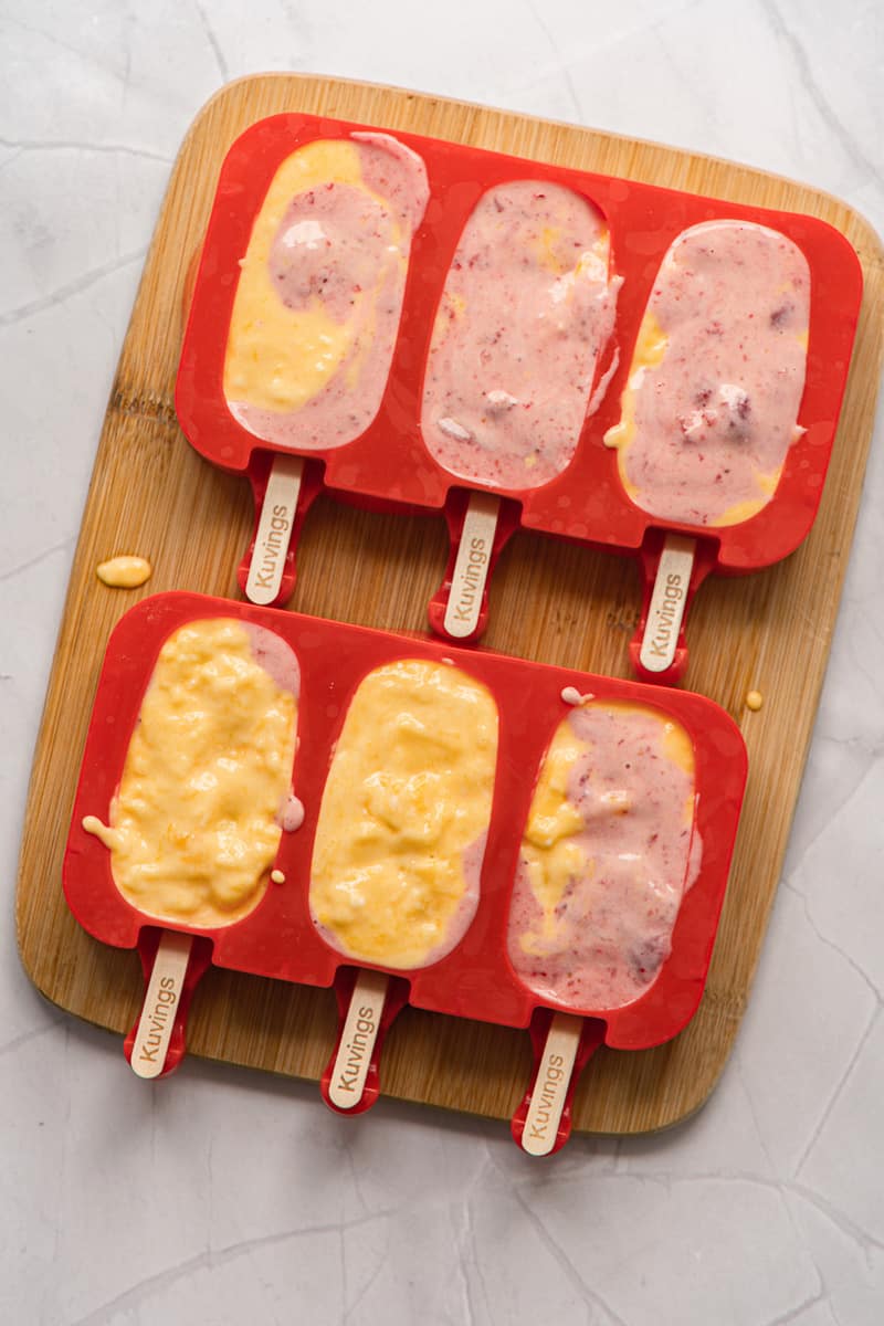 strawberry mango popsicles liquid mixture in molds